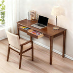 Walnut desk styled with a laptop, with drawers open showing interior storage