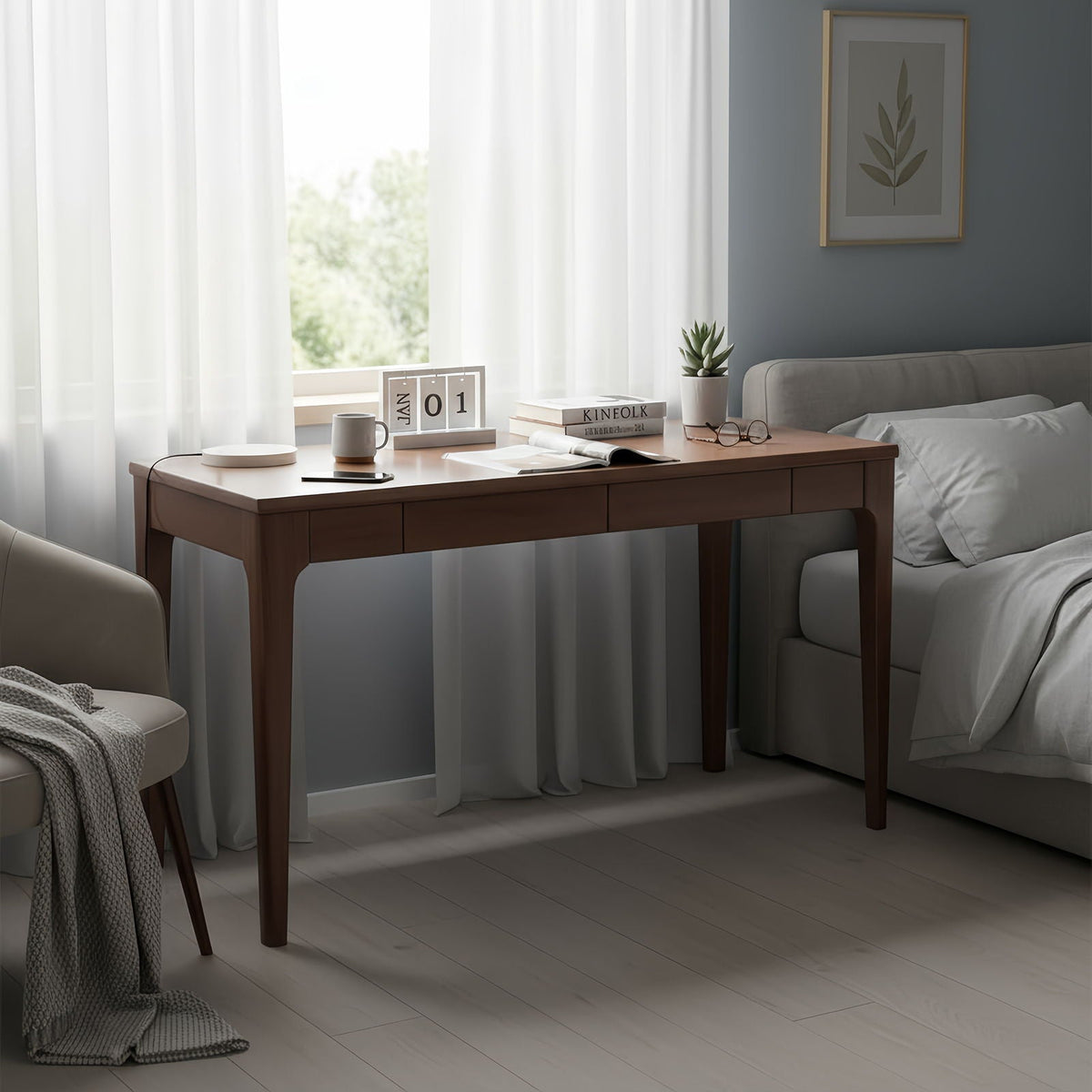 Walnut desk used as a bedside work surface in a bedroom setting