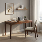 Walnut desk in a home office with a matching chair and wall shelf